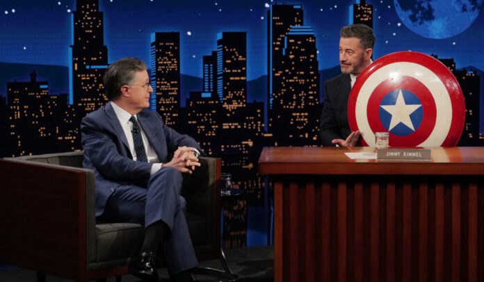 Stephen Colbert Jimmy Kimmel Captain America shield featured JIMMY KIMMEL LIVE! – “Jimmy Kimmel Live!” airs every weeknight at 11:35 p.m. ET and features a diverse lineup of guests that include celebrities, athletes, musical acts, comedians and human interest subjects, along with comedy bits and a house band. The guests for Tuesday, September 15 included Stephen Colbert, musical Guest Medium Build and Judith Hill sits in with The Cletones. (Disney/Randy Holmes) STEPHEN COLBERT, JIMMY KIMMEL