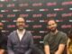 NYCC ‘26: The cast and co-creators of COMMON SIDE EFFECTS tease Season 2 (L-R) Joseph Lee Anderson, Steve Hely, Joe Bennett, and Emily Pendergast sitting at NYCC '26 smiling.