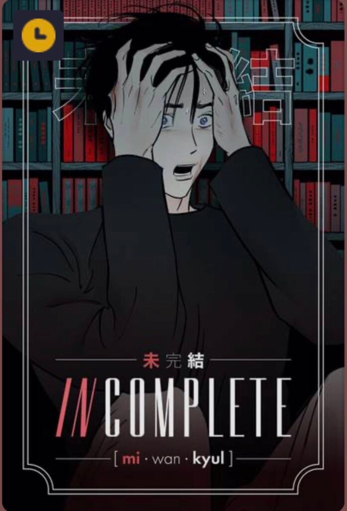 A man grips his head with his hands. he is wearing a long-sleeved black shirt.